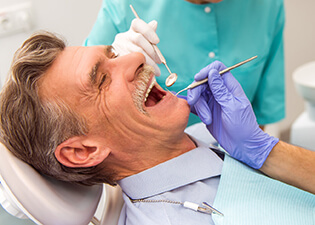 Older male patient in dental chair