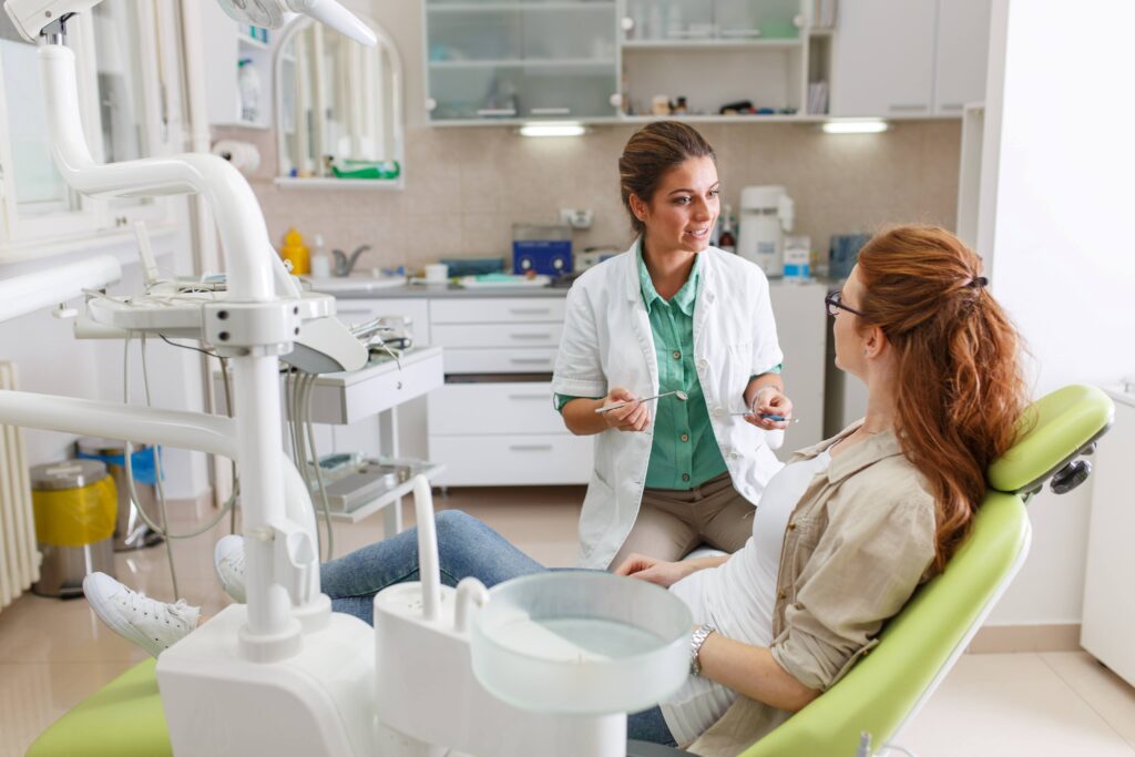 Smiling dentist answering patient's questions